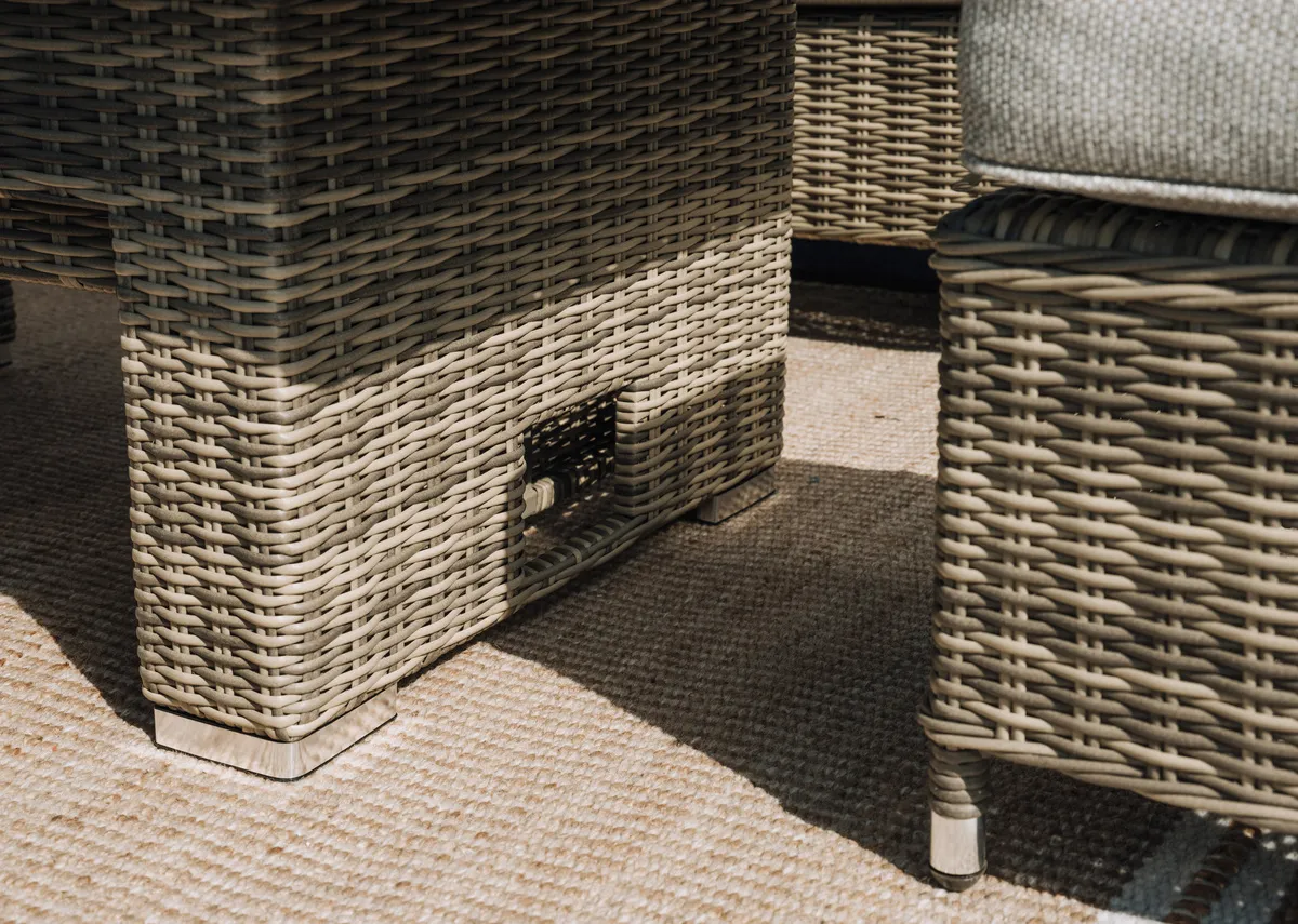 A grey woven corner garden set with rising table and 3 stools from EZ Living Furnitures Monterey range. Angled view of table risen