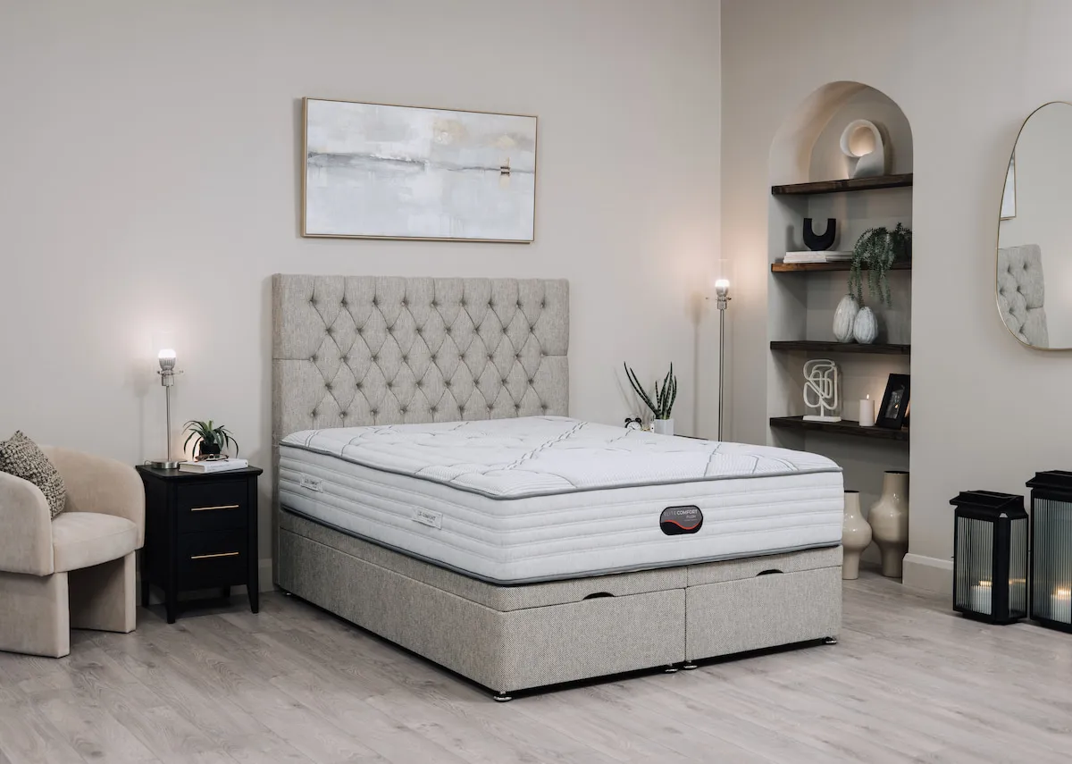A lifestyle image of the Elite Comfort plush mattress on a plaermo bed base with chevron locker and hope chair.
