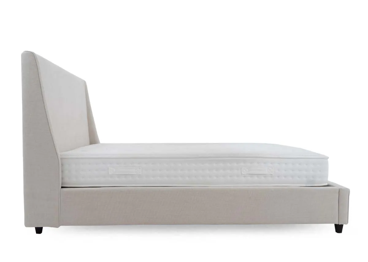 A beige fabric bed frame from EZ Livings Saoirse range. Side  view