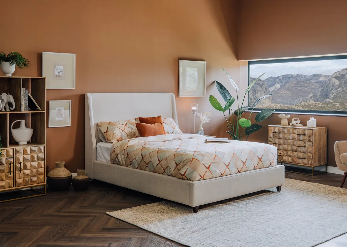 A lifestyle image of the Saoirse Beige bedframe with diva bookcase and chest.