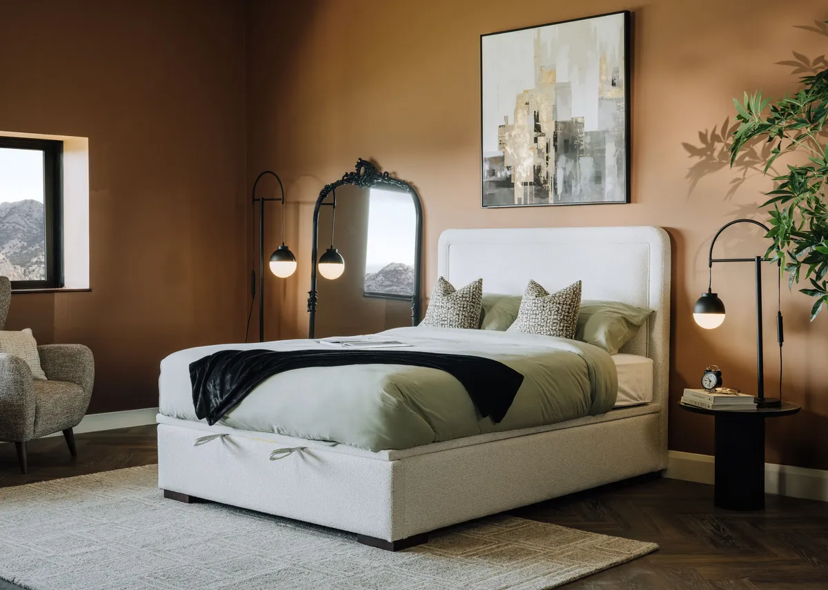 A lifestyle image of the Malmo cream ottman with Kacey mirror and Bronx armchair