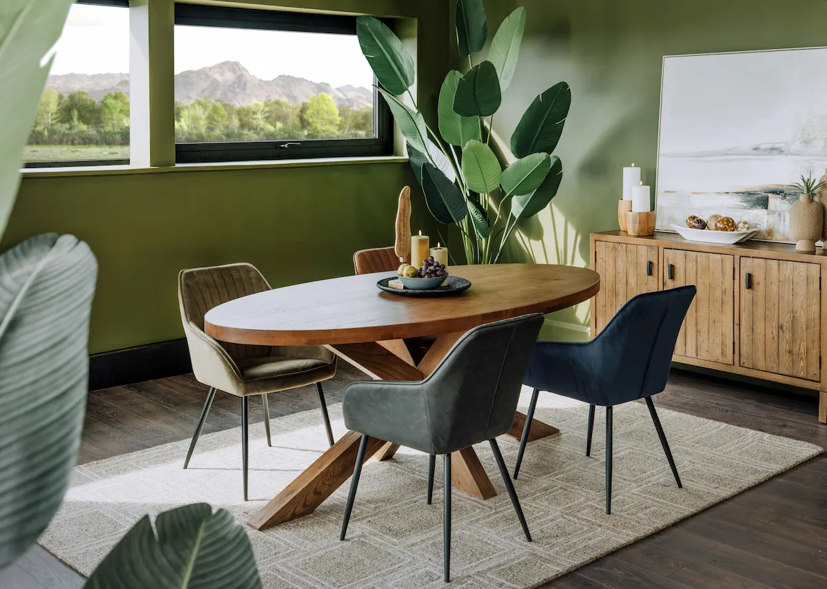 A lifestyle image of the Nolan chairs with the Oslo oval table and Ladder sideboard