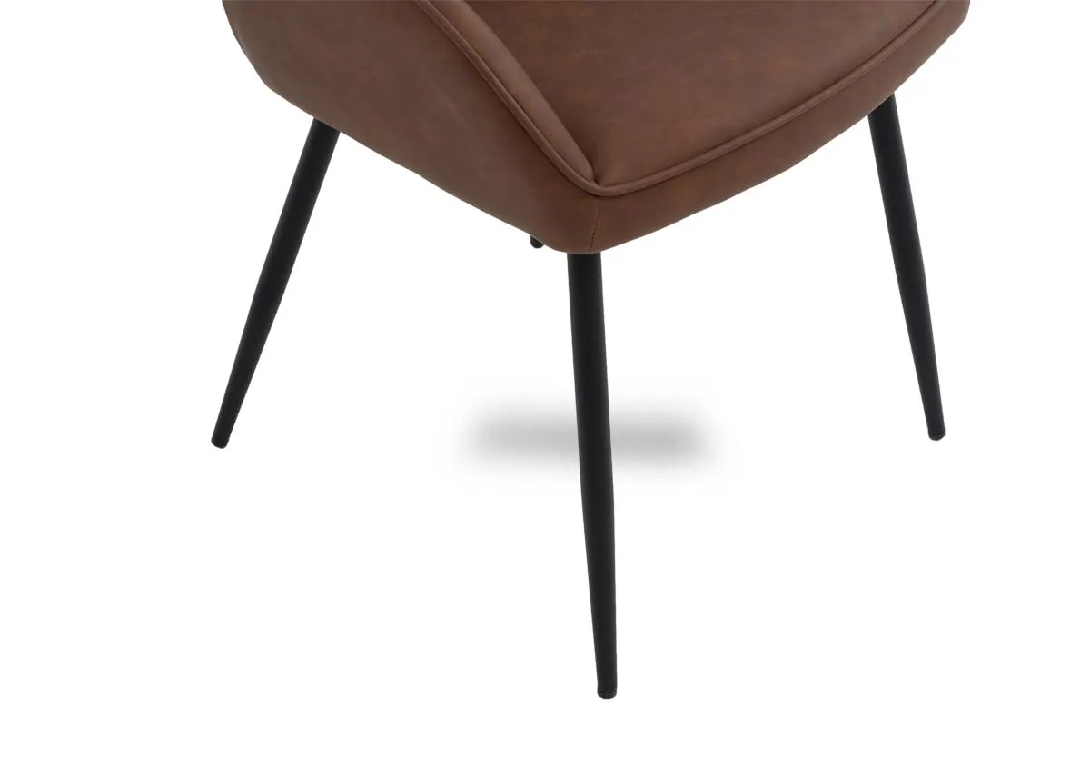 A closeup view of the Nolan dining chair with black polished metal legs