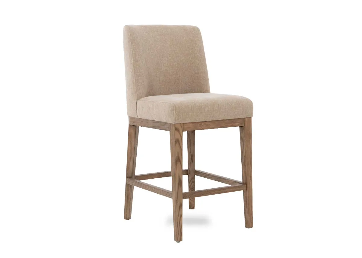 A natural oak counter stool from EZ Livings Naxos range. Angled view of padded seat and back.