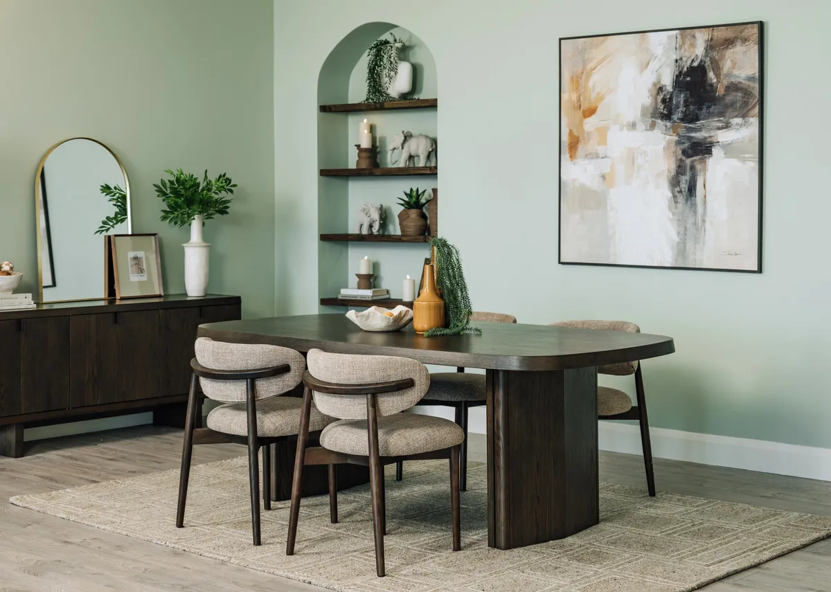 A lifestyle image of the Natu dining table and wishbone chairs with Memphis rug