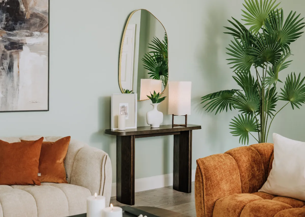 A lifestyle image of the Matera sofas with the Rimini console table with Colson mirror