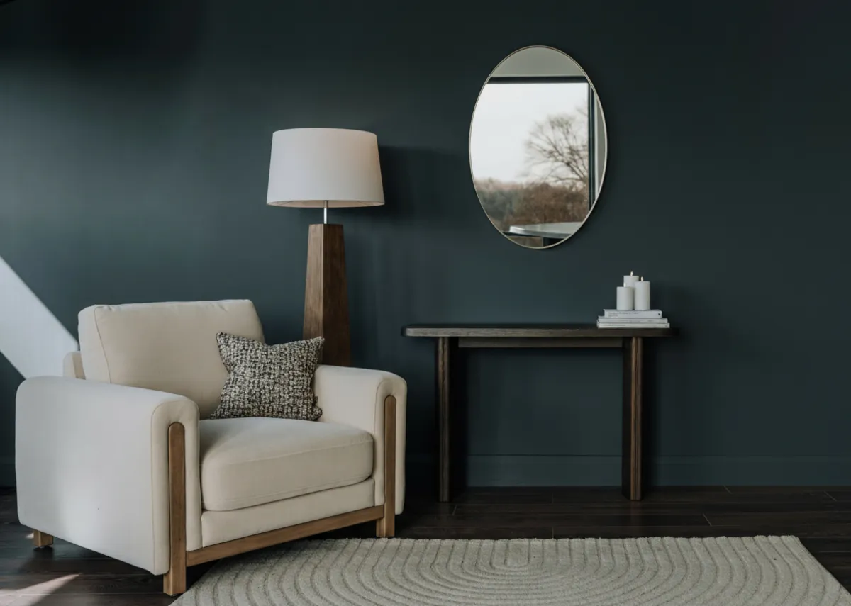 A lifestyle image of the Miller cream armchair with Beau mirror and Rimini console table.