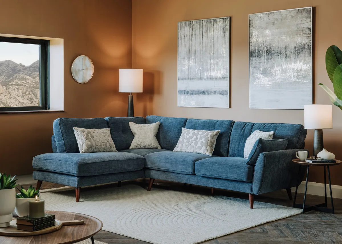 A lifestyle image of the Caoimhe denim corner chaise with Torrent I & 11 prints