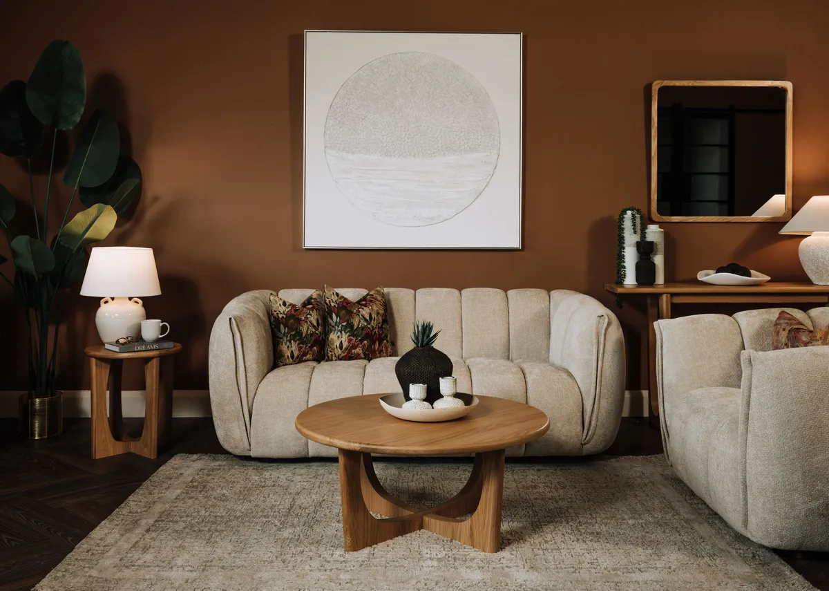 A lifestyle image of the Mater ivory sofa with Flow natural table.