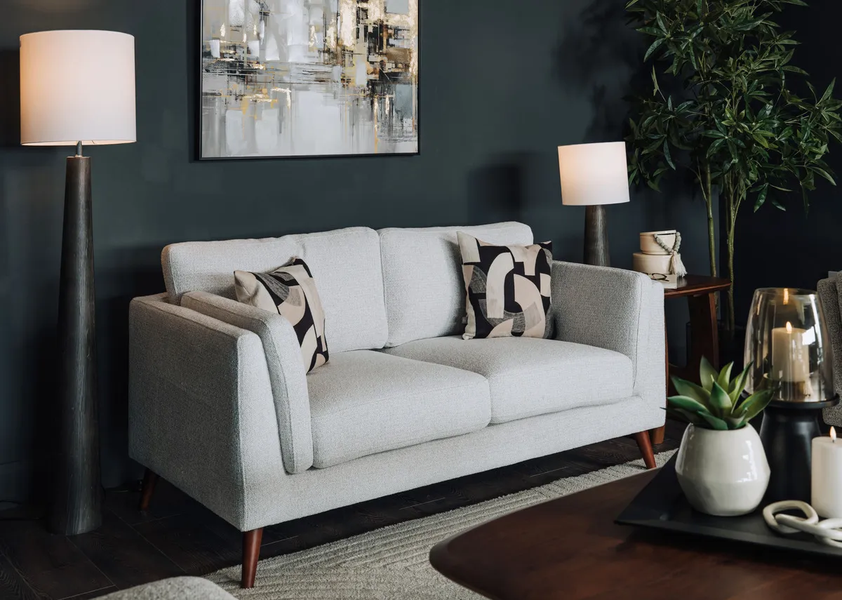 A lifestyle image of the Bailey sofa and tate floor and table lamps with Jet brown tables.