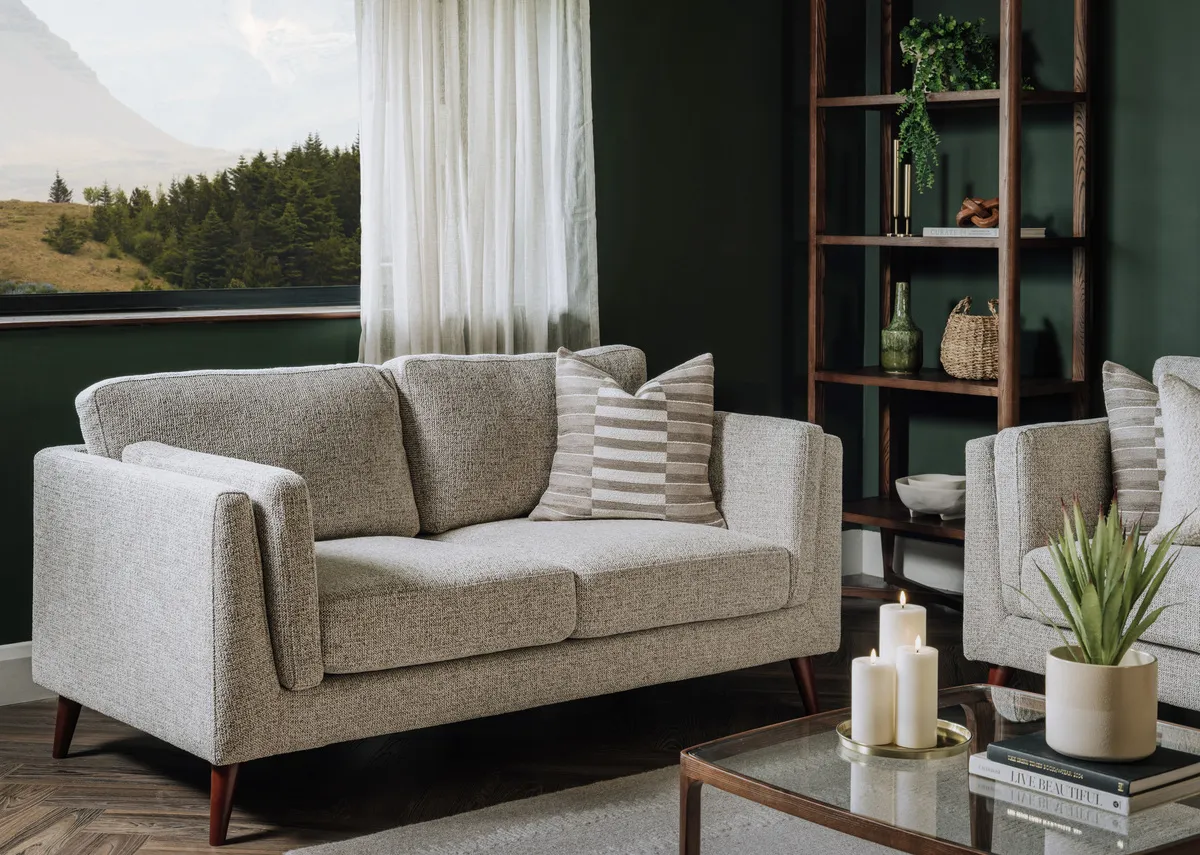 A lifestyle image of the Bailey brown sofa with Cameo bookshelf and coffee table.