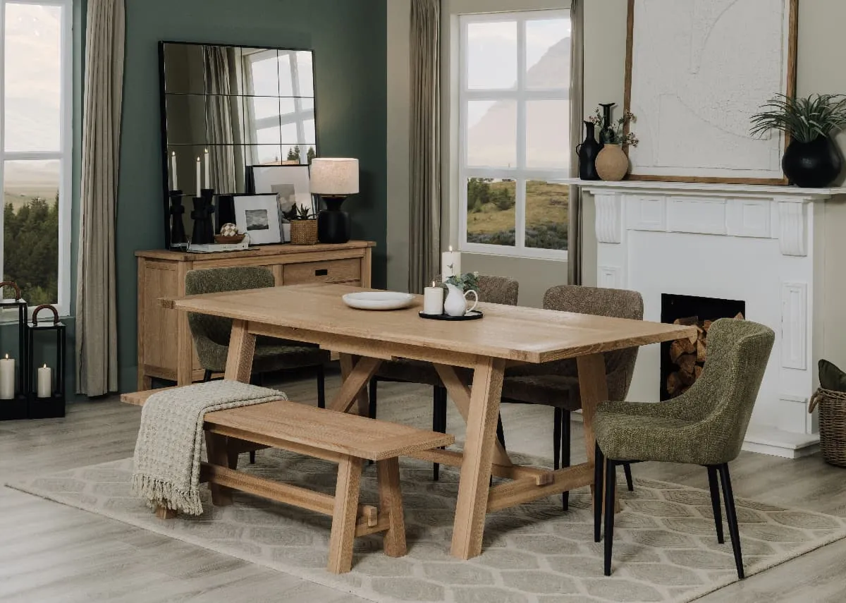 A lifestyle image of the Albany dining table and bench with the Dylan green chair
