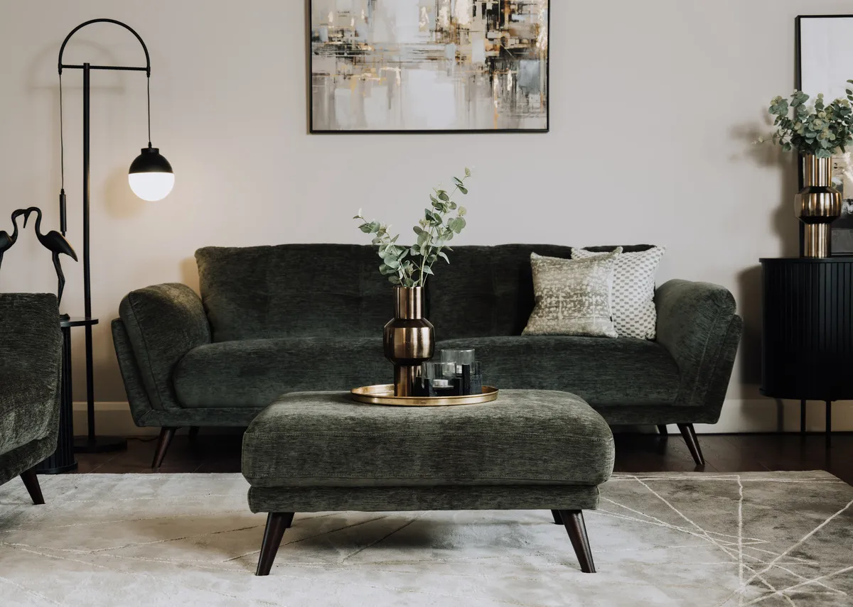 A lifetsyle image of the Toscana footstool with a tray and vase with the Toscana sofa.