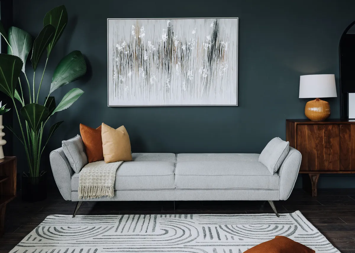 A lifestyle image of the Chloe sofa bed as a bed with the Arc side table