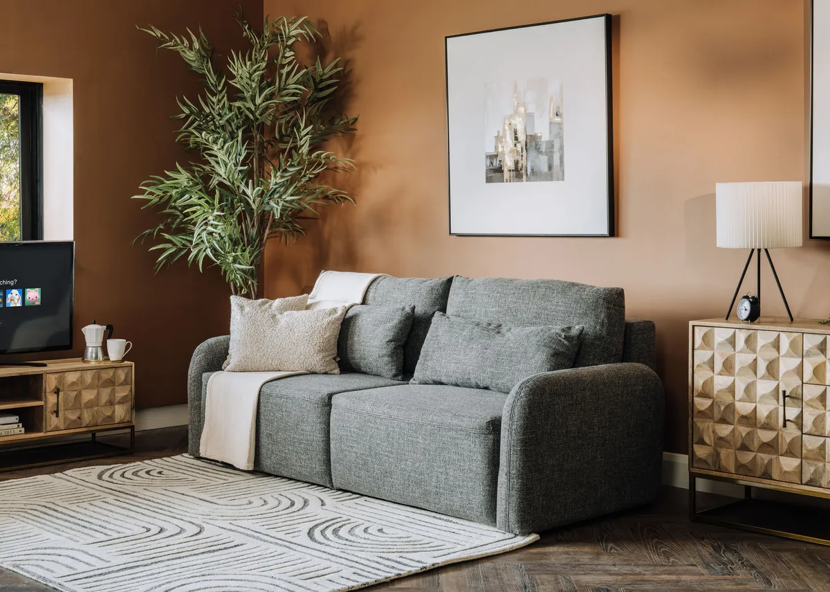 A grey fabric sofa bed from EZ Livings Brooks range. Angled view of bed reclined