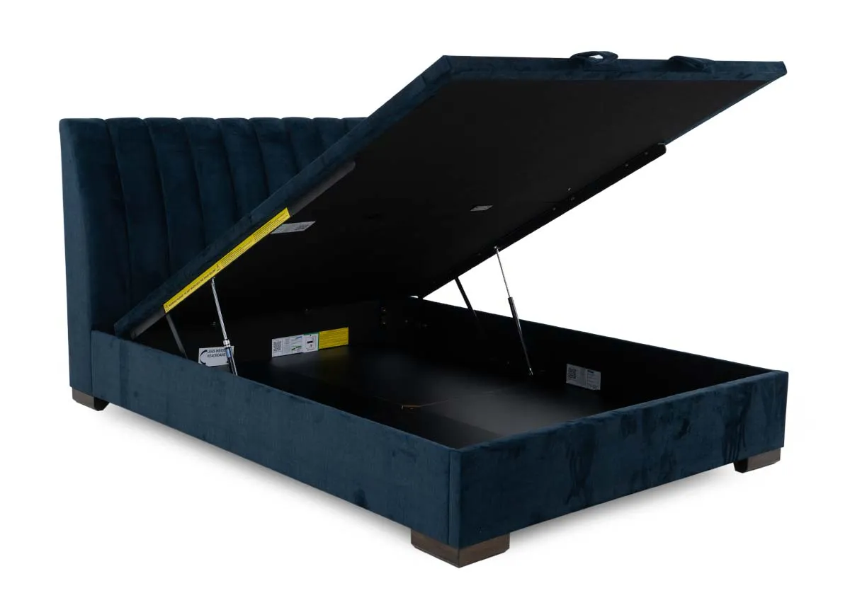 A 5ft ottoman bed in petrol blue from EZ Livings Lancelot range. Angled view of underbed storage