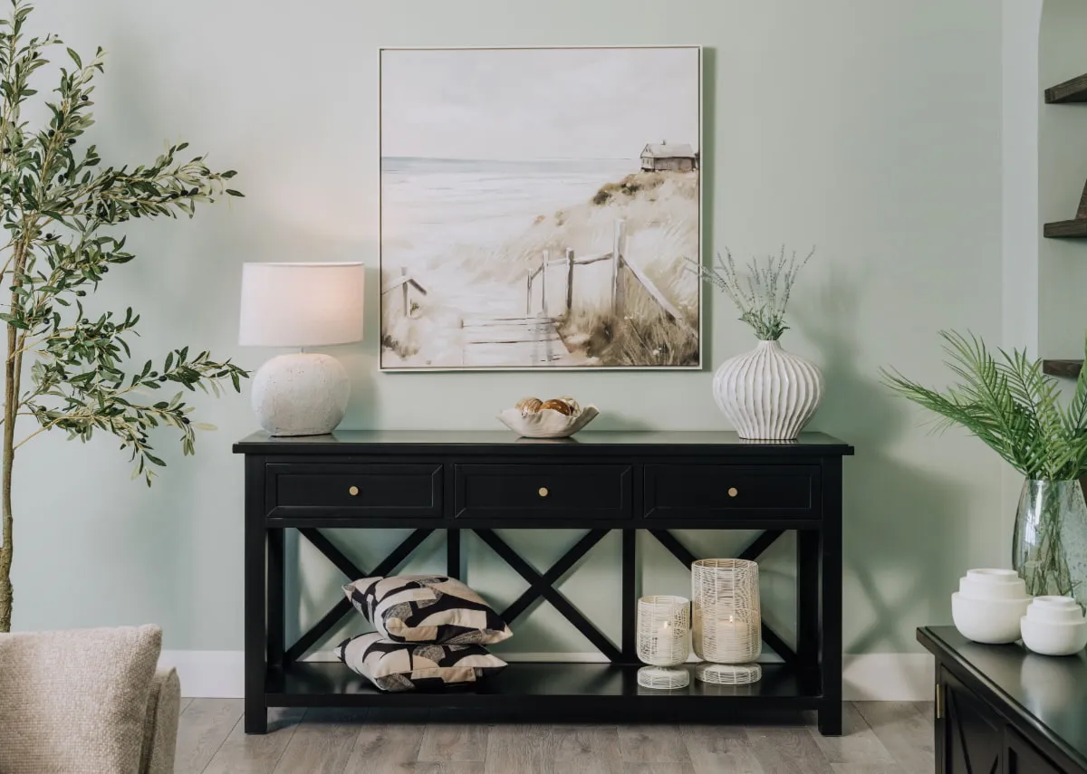 A lifestyle image of the Hamton 3 drawer console with Journey print and lamp