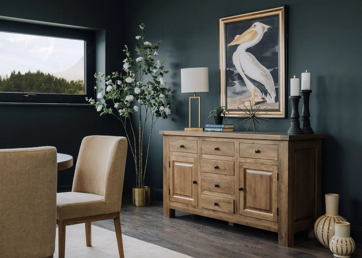 A lifestyle image of the Naxos sideboard with pelican canvas and shiva lamp.