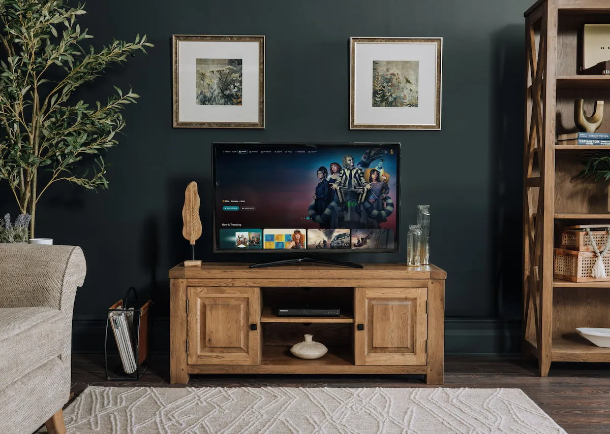 A lifestyle image of the Naxos tv unit with a tv and Perception and clarity pictures