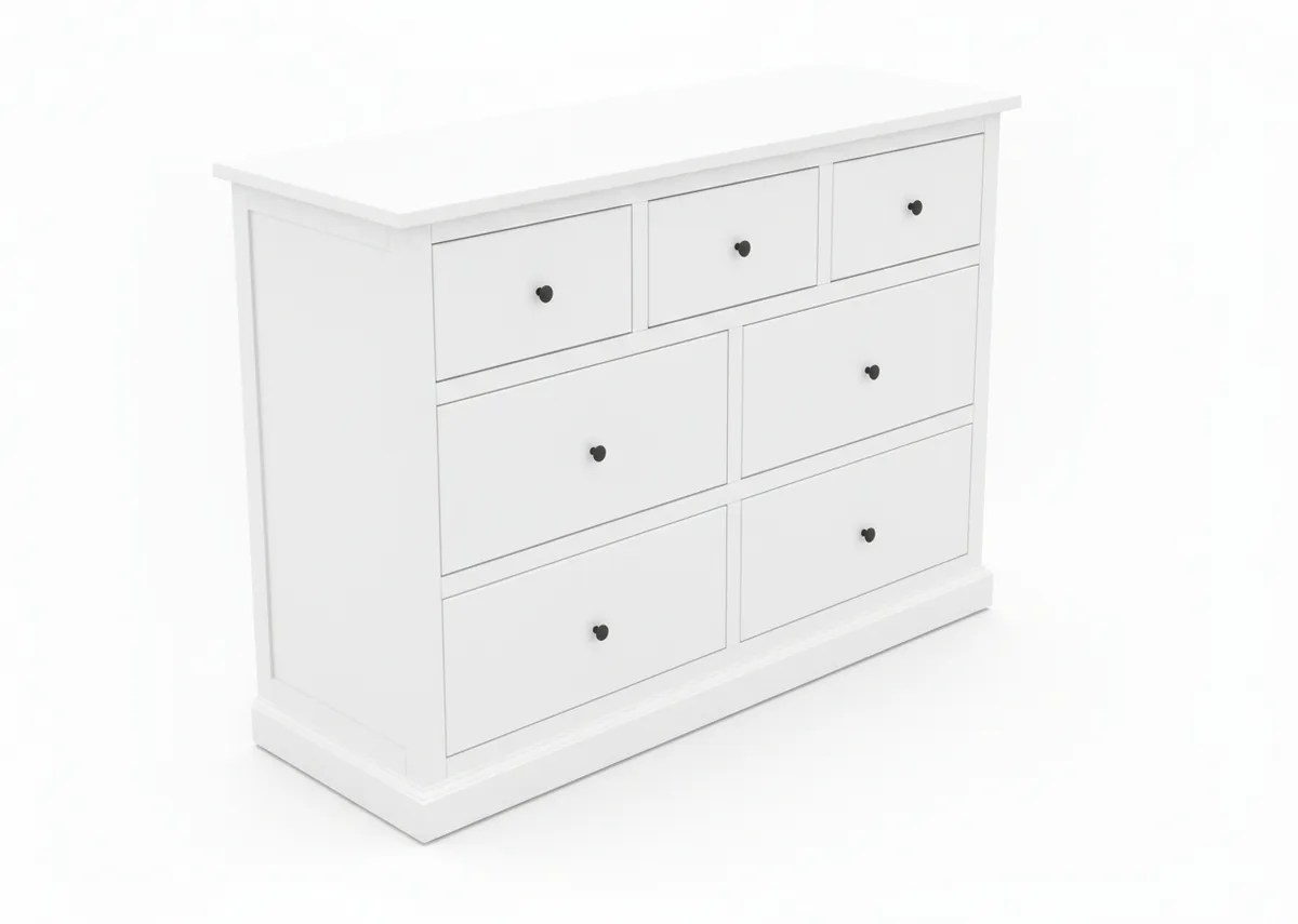 A white chest of drawers viewed from a top left angle featuring three smaller and four larger drawers with dark knobs.