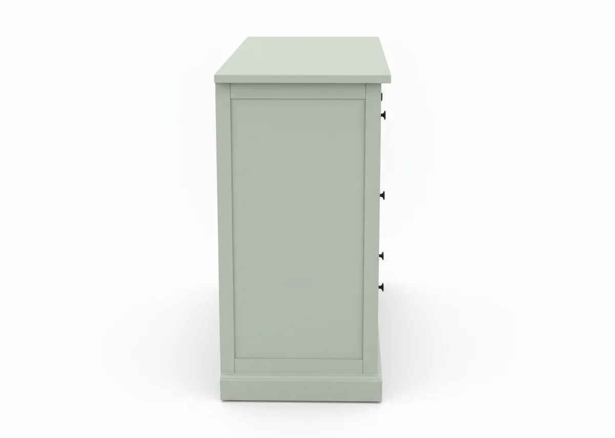 A light green chest of drawers shown from the right side featuring a flat top and four small black drawer pulls visible on the right edge.