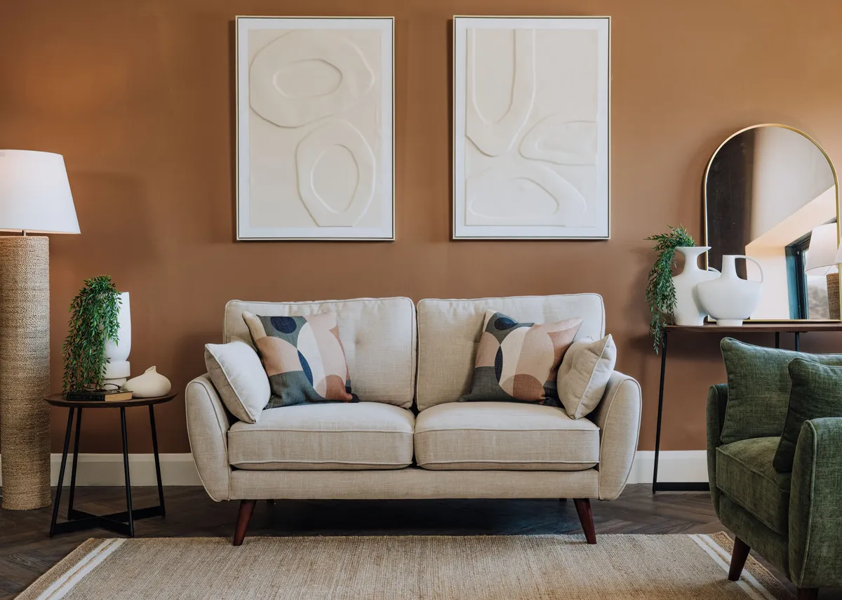 A lifestyle image of the Caoimhe cream sofa with the Gateway I & II prints above and Edith floor lamp.