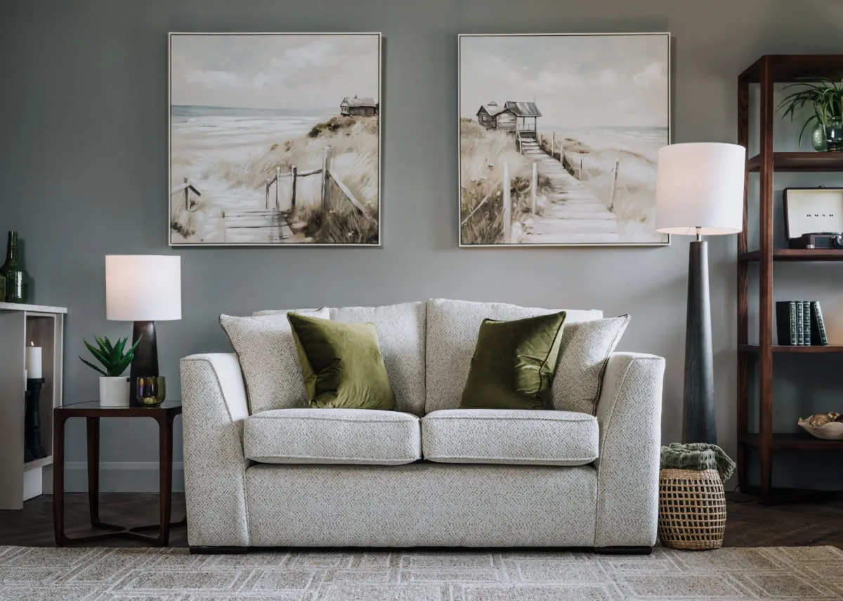 A lifetsyle image of the Carraroe 2 seater with Journey I & 2 prints with Cameo bookcase