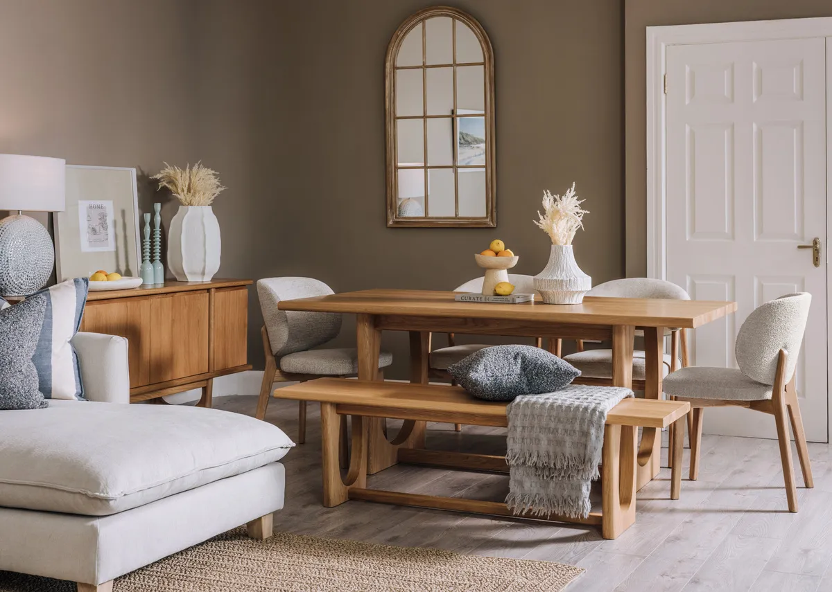 A lifetsyle image of the Mica mirror with the Albany dining table and chairs.