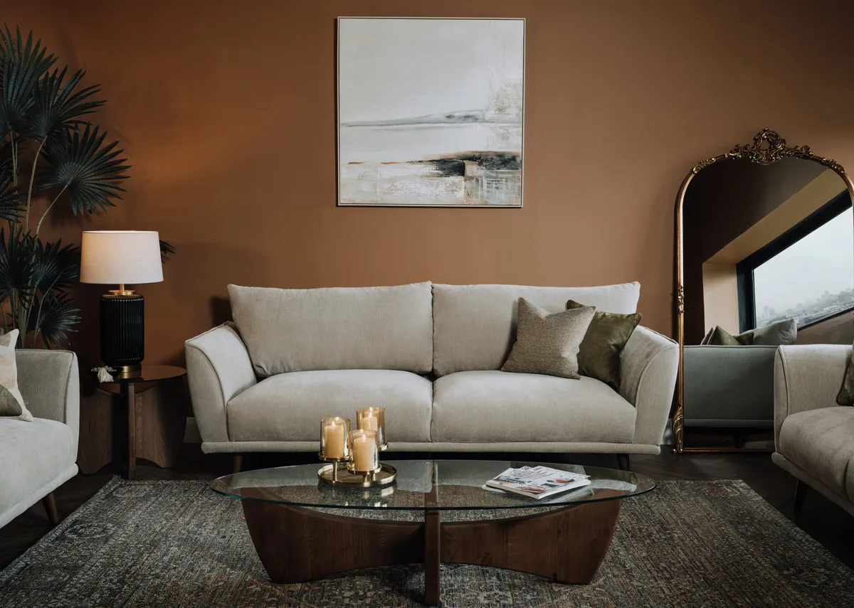 A lifetsyle image of the Boutique silver sofa with Cameo table and Kacey gold mirror.
