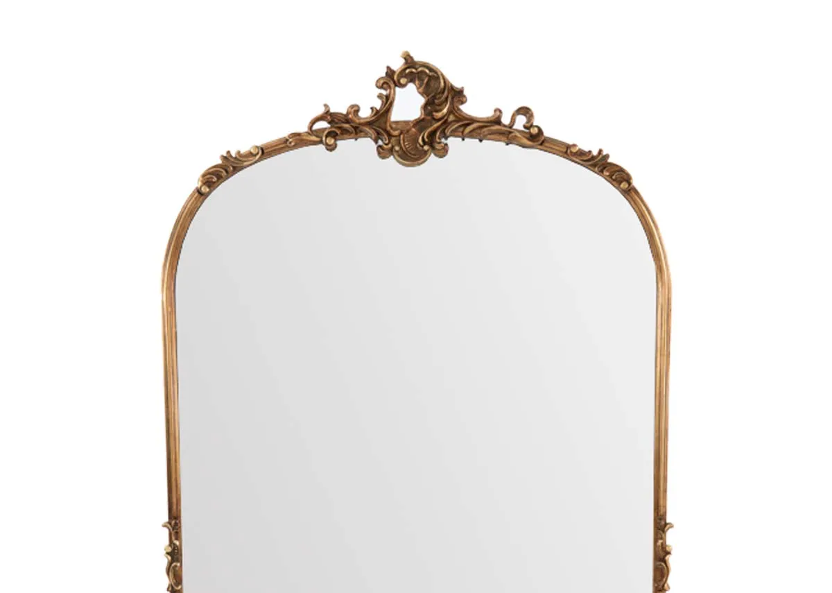 A large arched mirror with ornate gold trim from EZ Livings Kacey range. Closeup of gold design on centre
