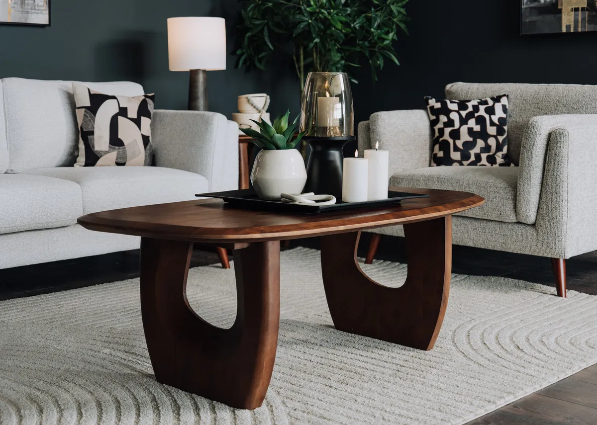 A lifestyle image of the Jet brown coffee table with Bailey sofas and Elio rug.