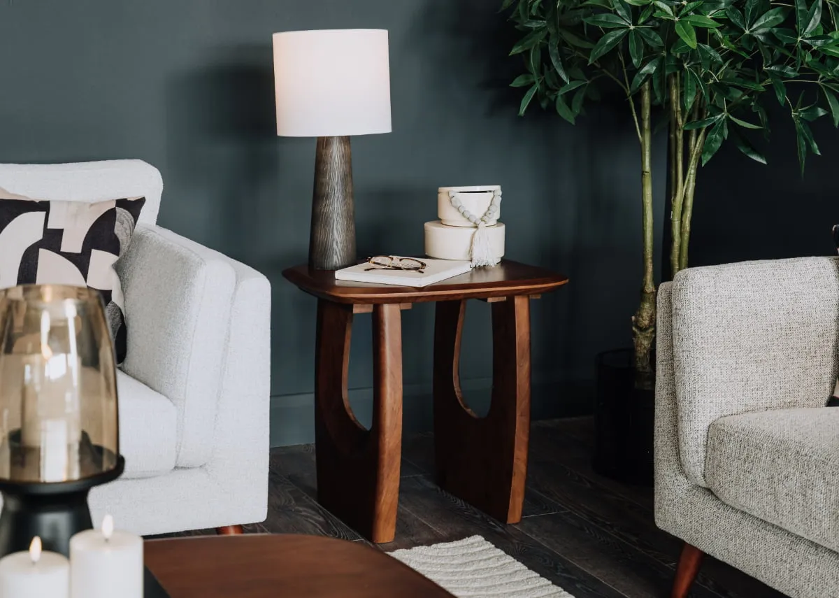 A lifestyle image of the Jet side table with talon boxes and tate lamp.
