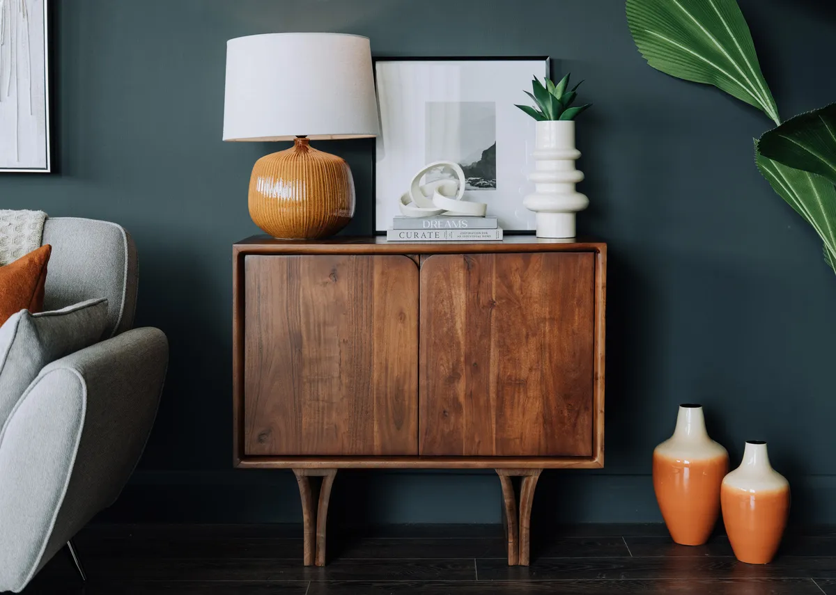 A lifestyle image of the Arc sideboard with porter vase with links ornament