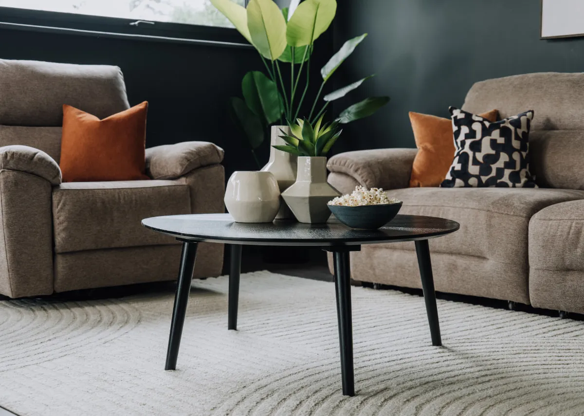 A lifestyle image of a coffee table with a selection of vases including the briggs and grady.