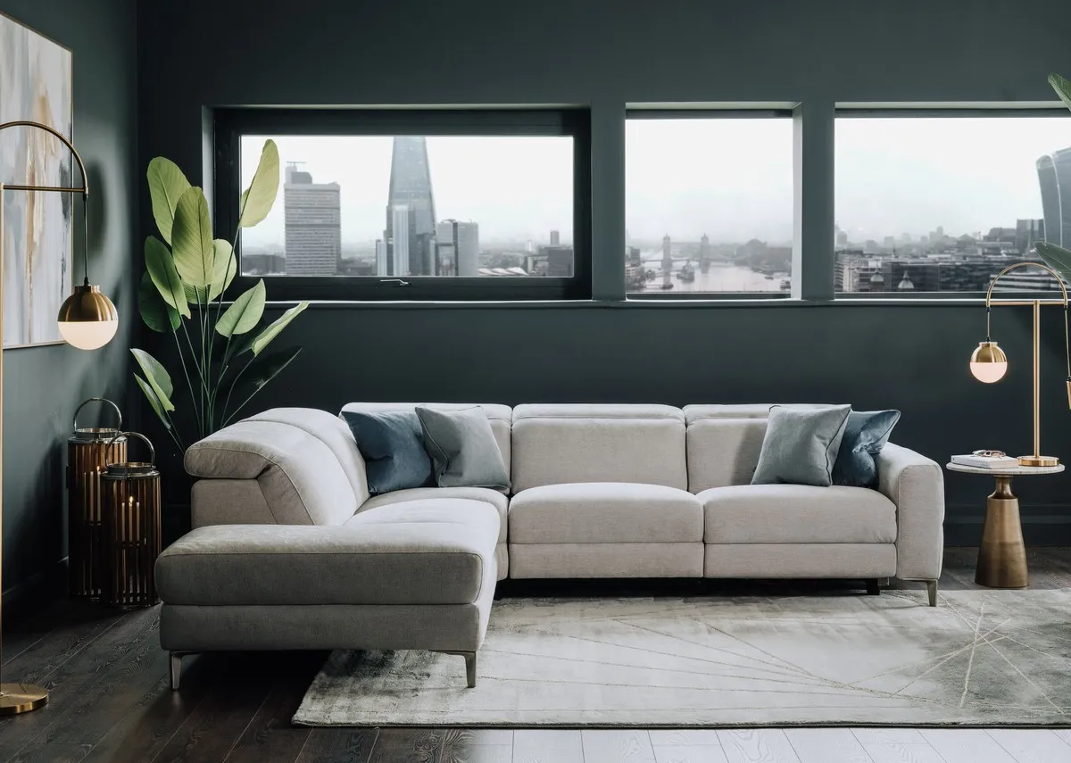 A lifestyle image of the Vancouver LHF chaise reclined with avery rug and sonoma black tables