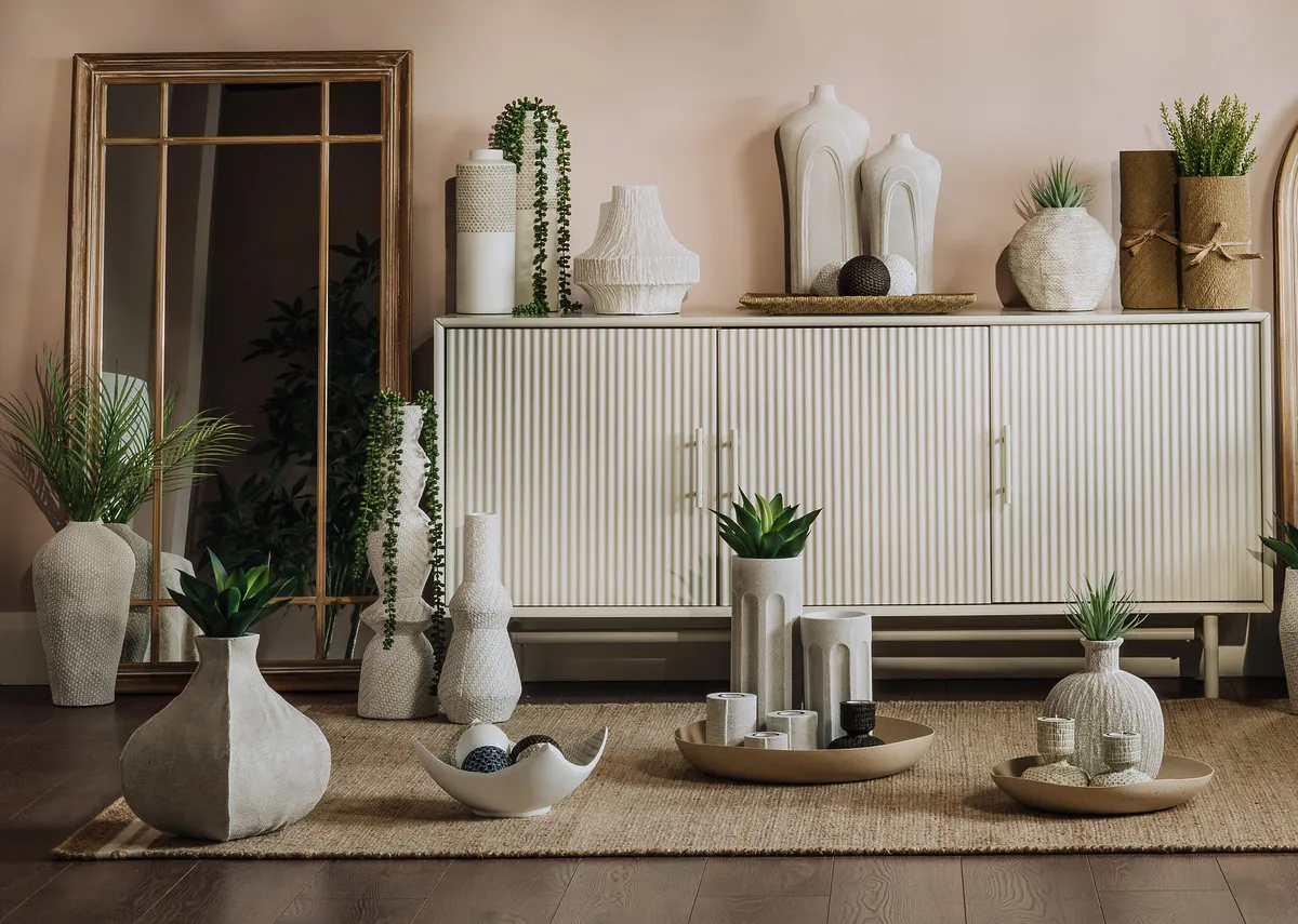 A creative lifetsyle image of the Resin light collection on the Palma sideboard and Novato rug
