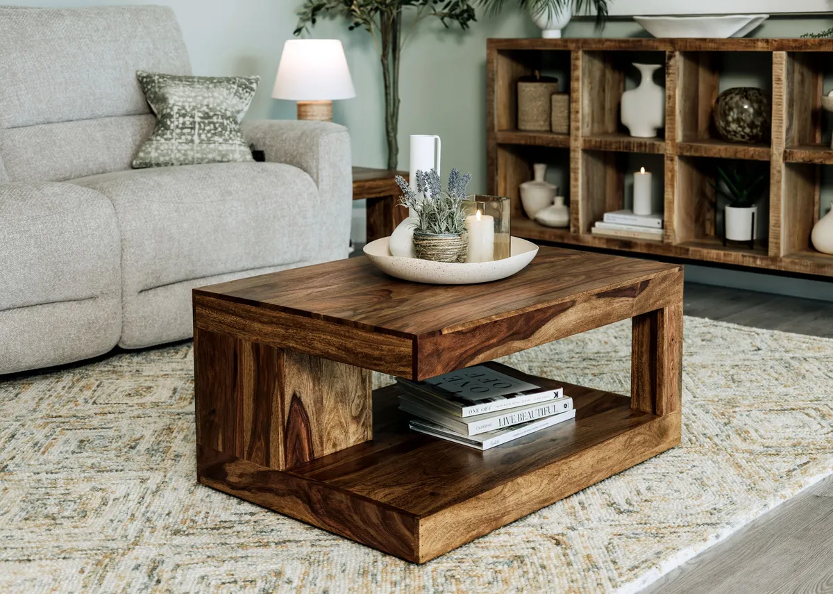 A lifestyle image of the Cube Coffee Table with dish and candles paired with the Ashbrook sofa and the Avoca bookcase.