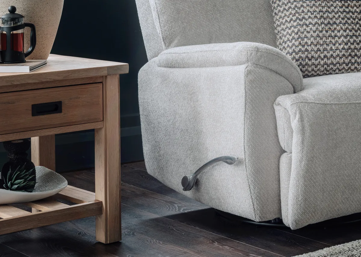 A silver fabric rocker swivel recliner from EZ Livings Mallow range. Side view of chair reclined