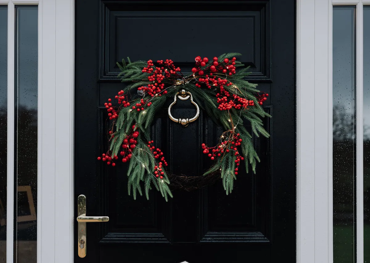 A lifestle image of the Berry hanging wreath on a front door