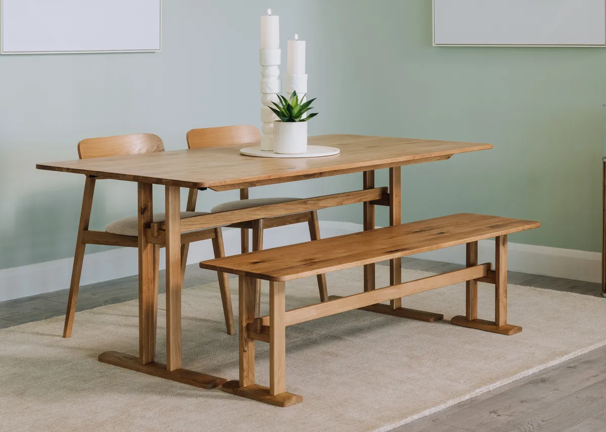A lifestyle image of the Hudson dining table and bench with Hudson dining chairs