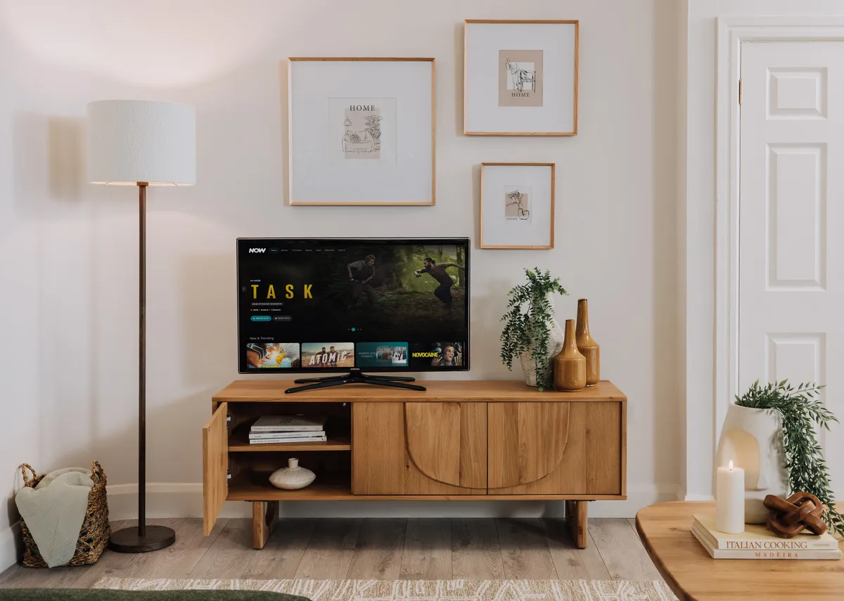 A lifetsyle image of the Pierro tv unit with door open showing interior shelving.