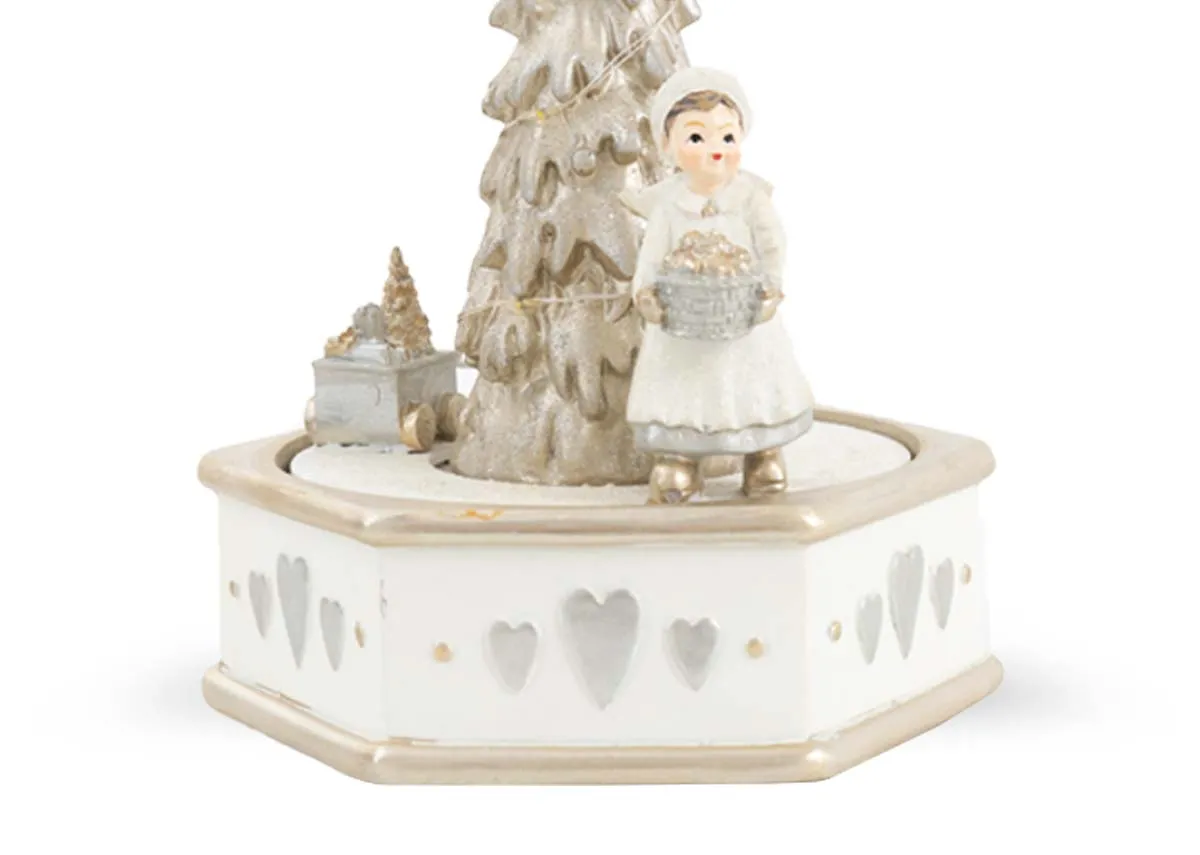 A white and gold LED music box with tree and singer. Closeup of detail on carousel