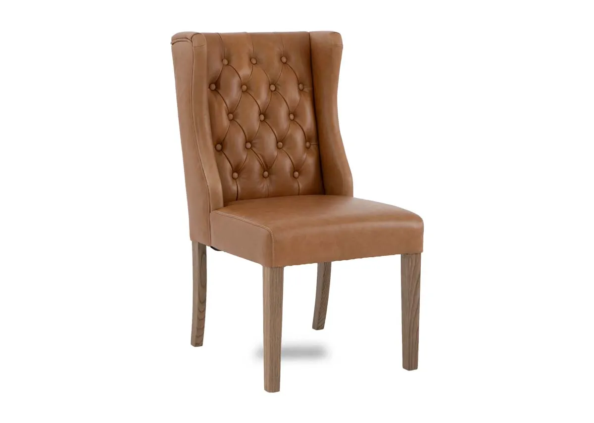 A tan leather dining carver chair from EZ Livings Naxos range. Angled view of winged sides