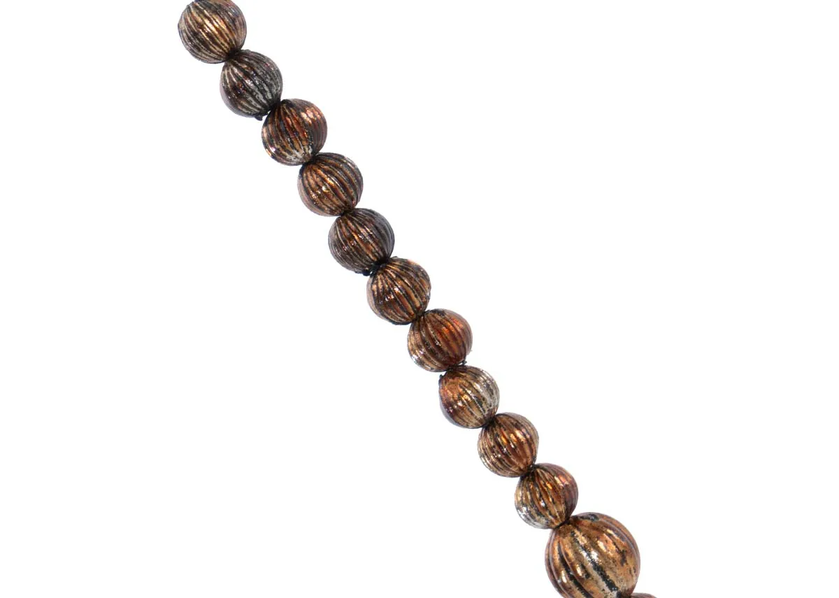 A close up of the textured brown beads on a brass small crystal garland showcasing their ribbed pattern and warm tone.