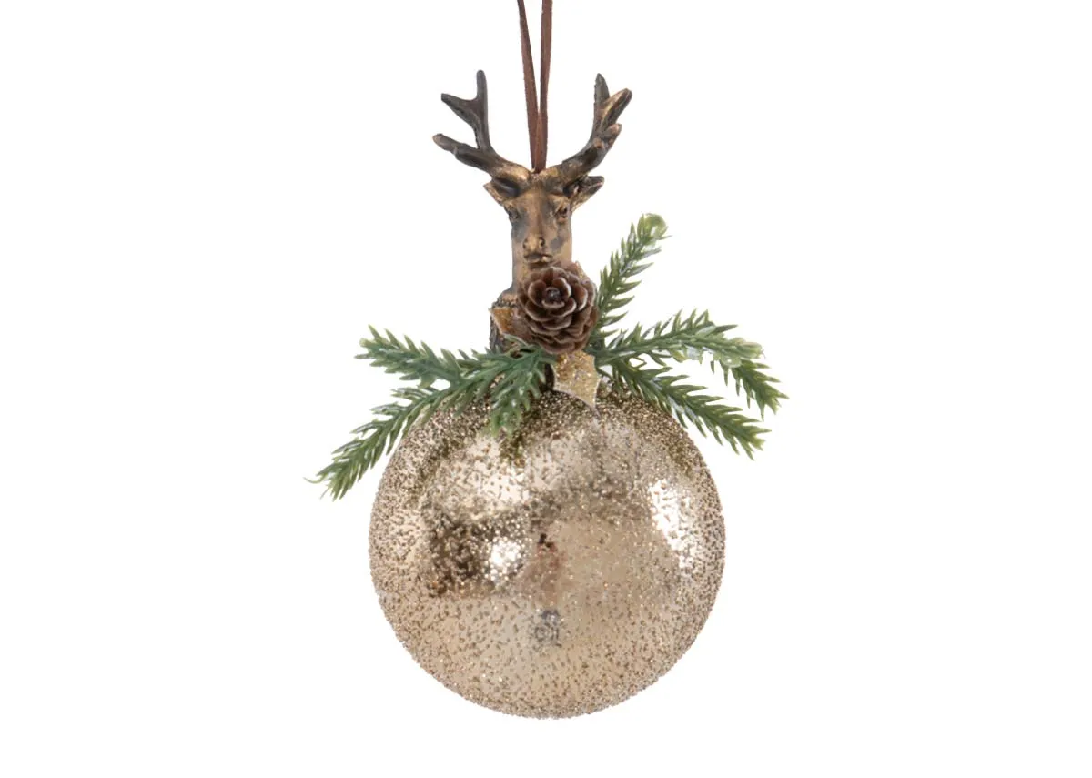A gold glittered bauble ornament topped with a detailed deer head pinecone and green foliage hanging from a brown string.