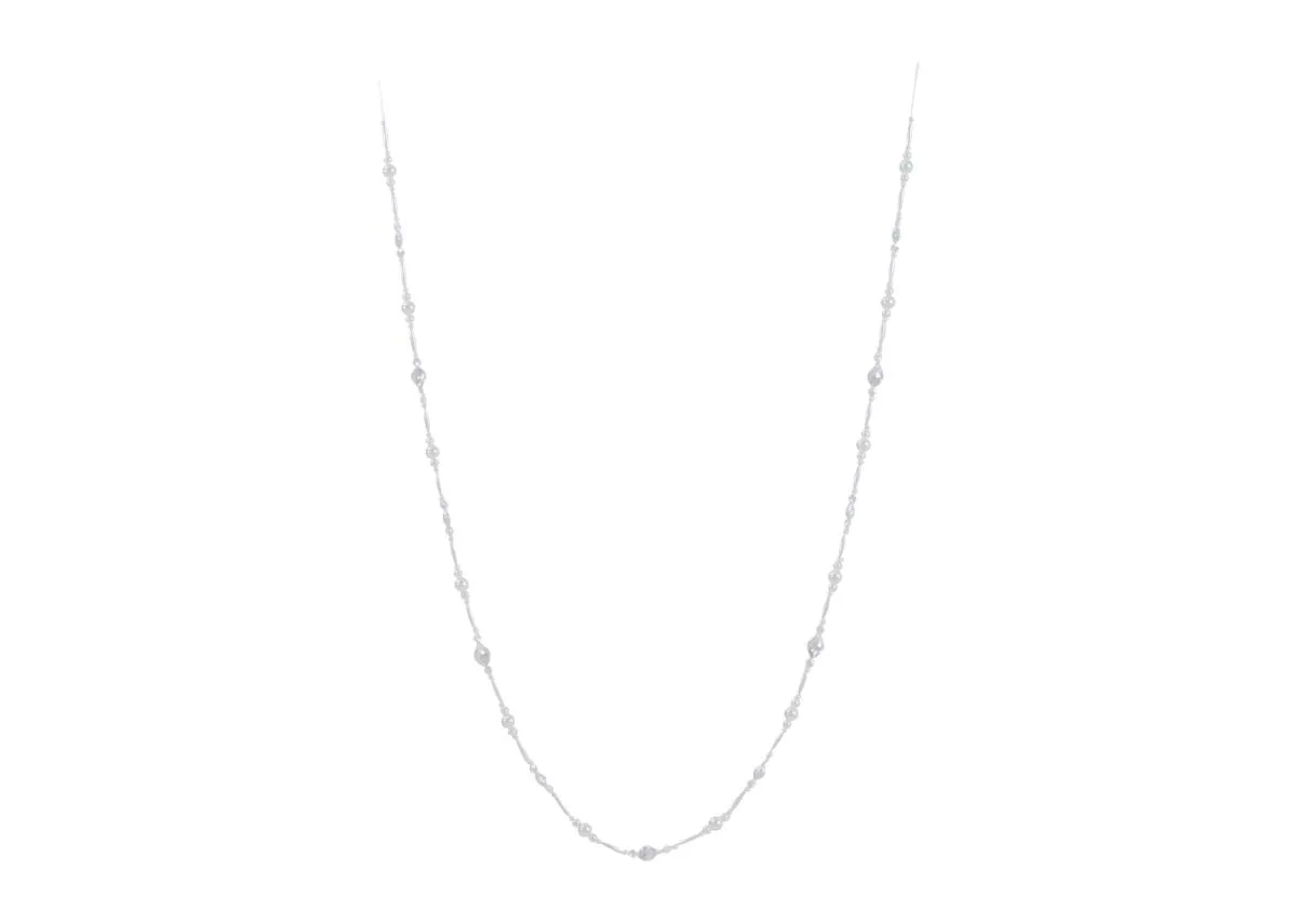 A full view of the cream large pearl garland elegantly draped to showcase its length and varying pearl shapes.