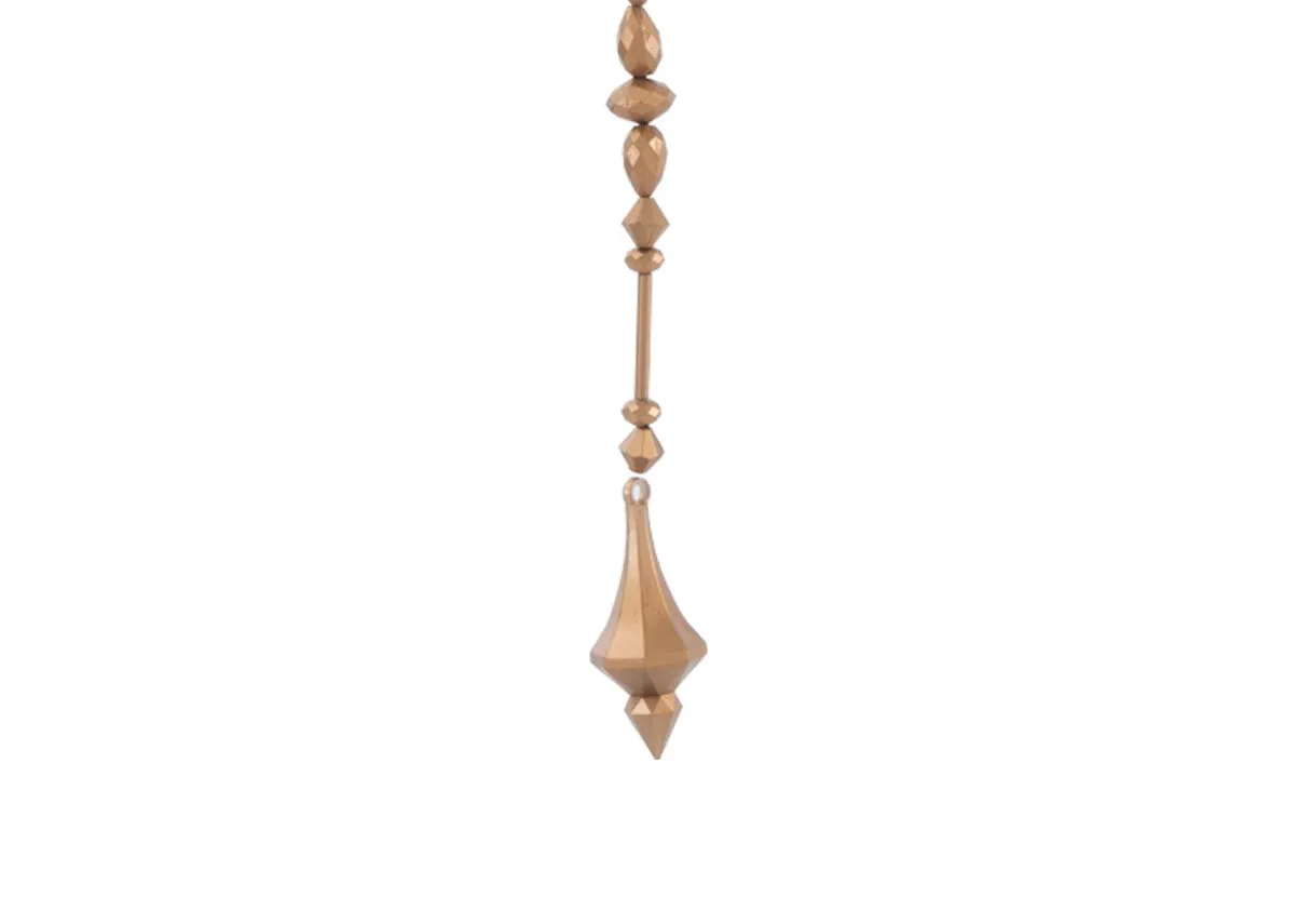 A brass diamond garland featuring a string of textured faceted brass beads in various shapes leading to a diamond shaped finial.