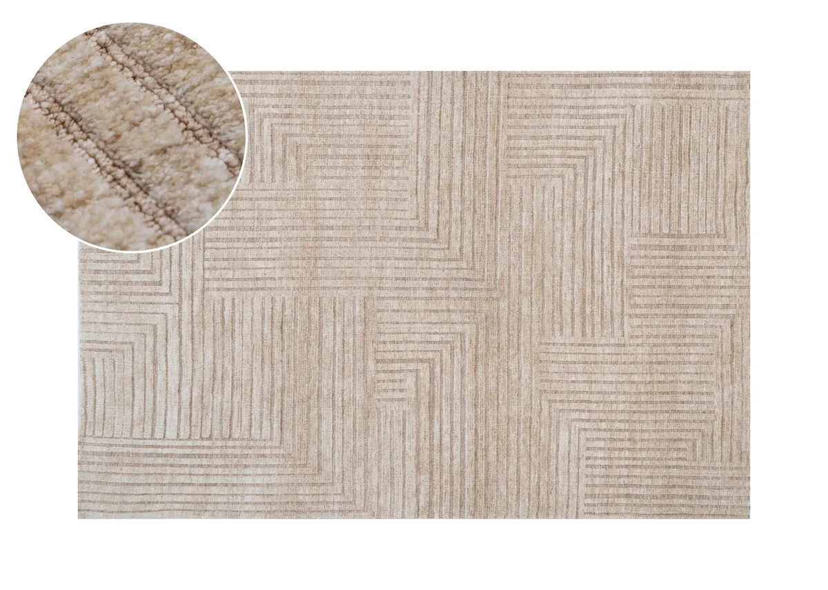 A rectangular sand colored rug with a geometric pattern of raised horizontal and vertical lines viewed from directly above.