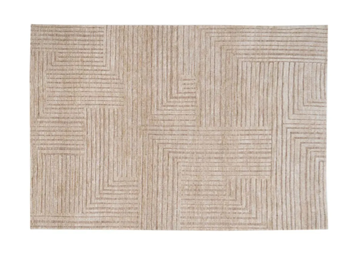 A rectangular sand colored rug with a geometric pattern of raised horizontal and vertical lines viewed from directly above.