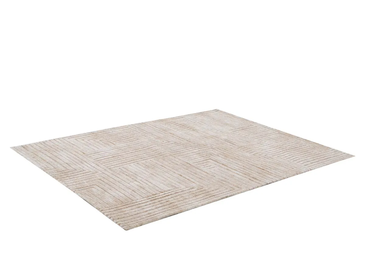 A rectangular sand colored rug with a geometric pattern of raised horizontal and vertical lines viewed from an elevated angle.